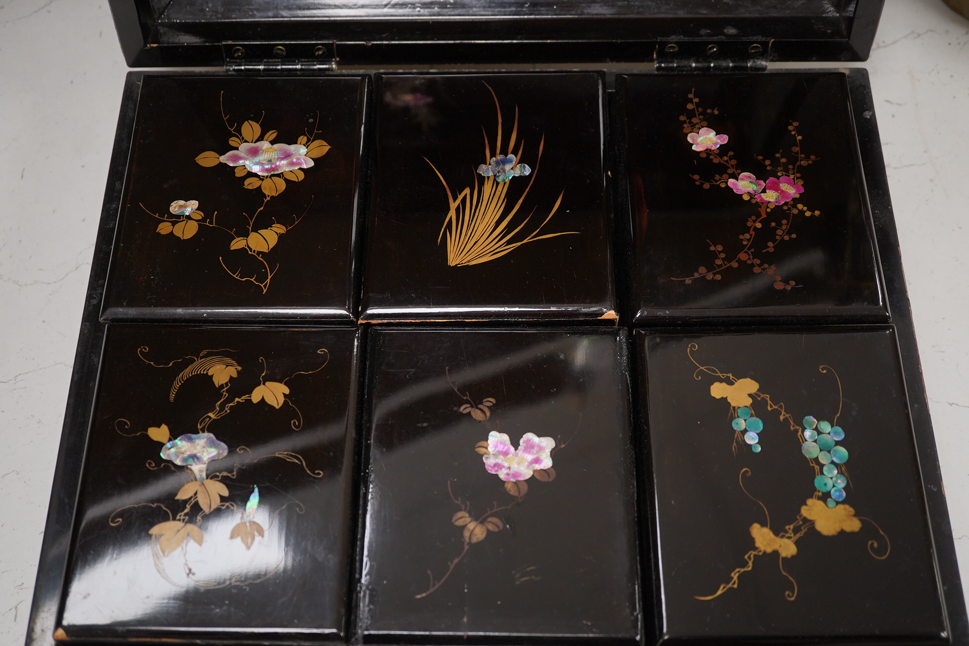 A Japanese lacquered box with mother of pearl inlay of birds and flowers, 35.5cm wide. Condition - worn on the outside to be expected, inside good